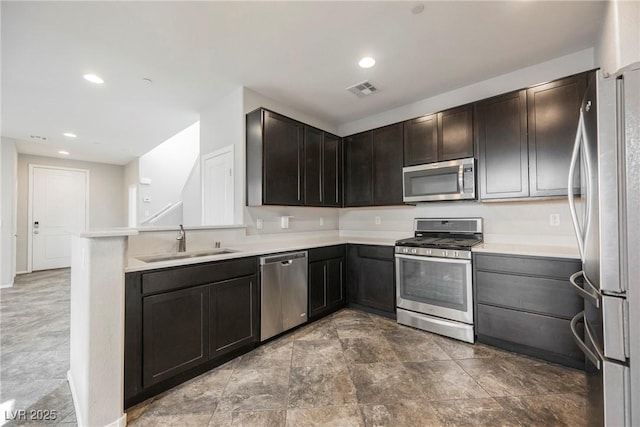 3158 Teaderman Walk, Henderson, NV 89044 - kitchen featuring appliances with stainless steel finishes, a sink, light countertops, recessed lighting, and a peninsula