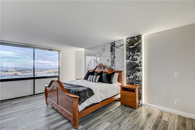 205 E Harmon Ave Unit 1010, Las Vegas, NV 89169 - bedroom featuring light wood-style flooring and baseboards
