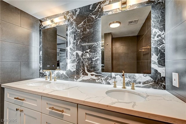 205 E Harmon Ave Unit 1010, Las Vegas, NV 89169 - full bath with double vanity, a sink, visible vents, and tile walls