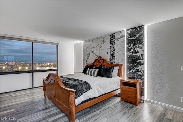 205 E Harmon Ave Unit 1010, Las Vegas, NV 89169 - bedroom with a textured wall and wood finished floors