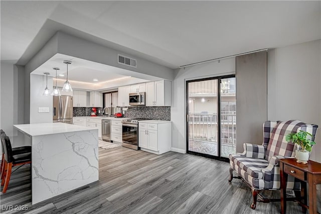205 E Harmon Ave Unit 1010, Las Vegas, NV 89169 - kitchen with a sink, visible vents, appliances with stainless steel finishes, and white cabinetry