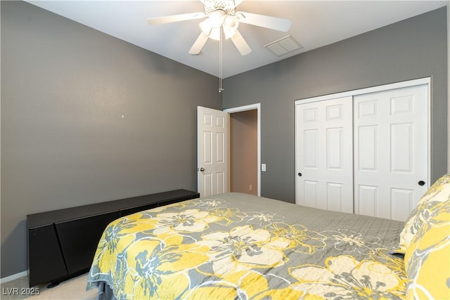 bedroom with a closet, visible vents, ceiling fan, and carpet flooring