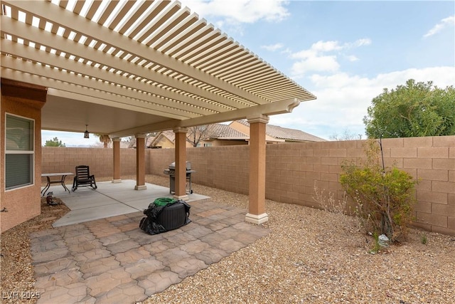 view of patio / terrace with area for grilling, a pergola, and a fenced backyard