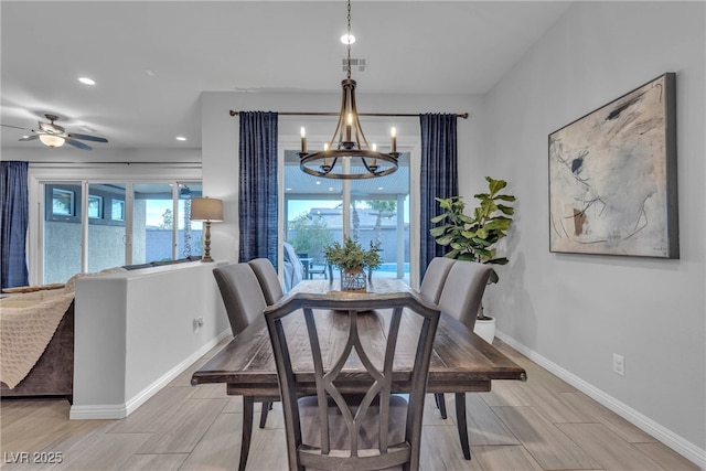 dining space with recessed lighting, baseboards, wood tiled floor, and ceiling fan with notable chandelier