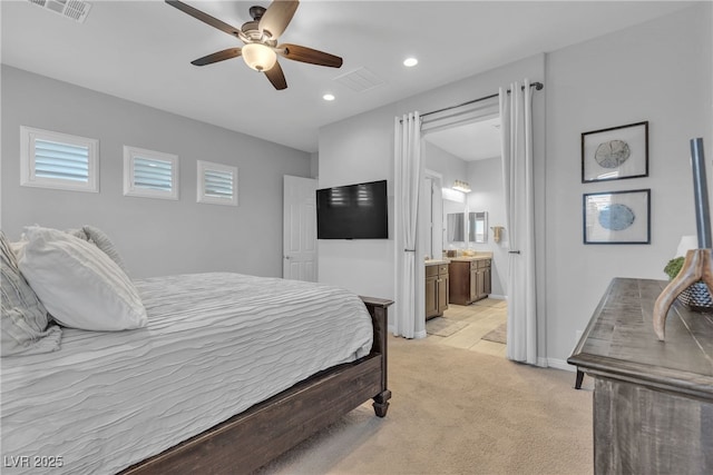 bedroom featuring recessed lighting, visible vents, light colored carpet, and ensuite bathroom