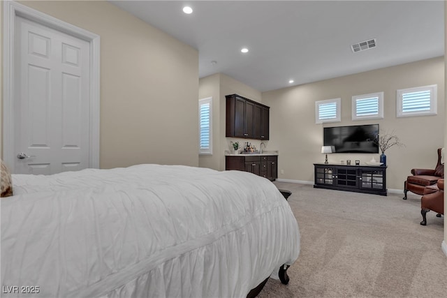 bedroom with recessed lighting, visible vents, light carpet, and baseboards