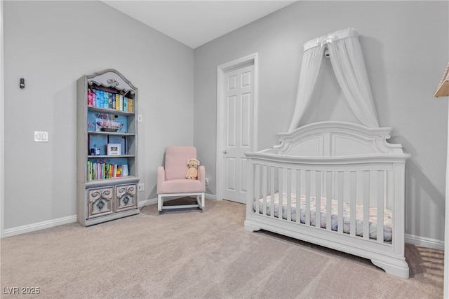 bedroom with baseboards, carpet, and a nursery area