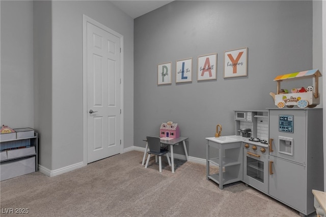 home office featuring baseboards and light carpet