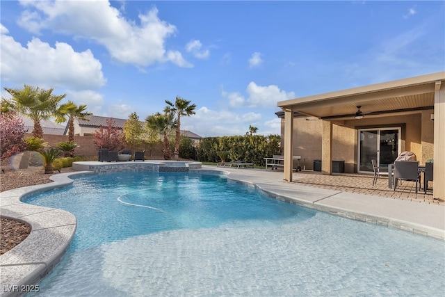 view of swimming pool with a patio area, a pool with connected hot tub, a ceiling fan, and a fenced backyard