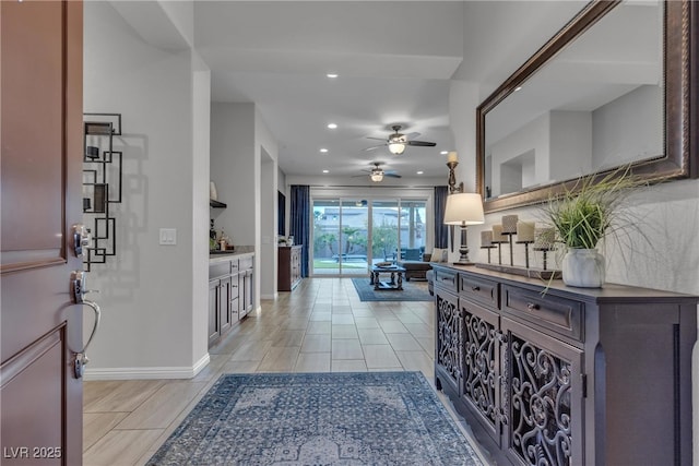 hall with recessed lighting and baseboards