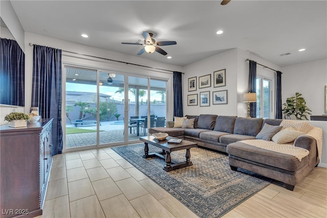 living area featuring a wealth of natural light, visible vents, recessed lighting, and a ceiling fan