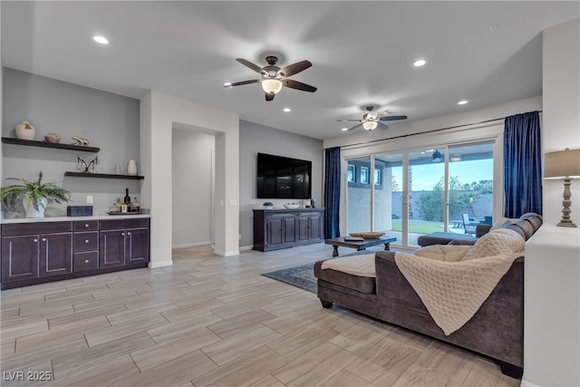 living room featuring recessed lighting, a ceiling fan, baseboards, and wood tiled floor