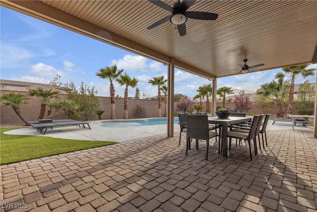 view of patio featuring outdoor dining space, a fenced backyard, and a fenced in pool