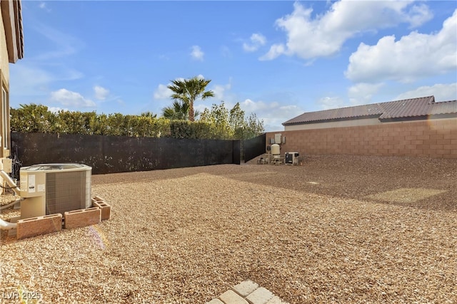 view of yard featuring central air condition unit and a fenced backyard