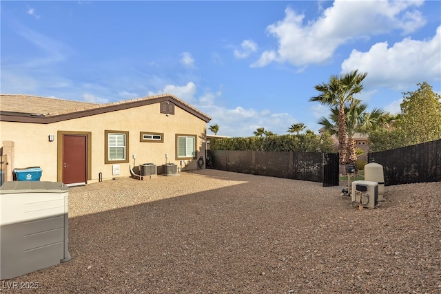 view of yard with central air condition unit, a patio, and fence