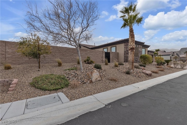 view of property exterior featuring fence private yard and stucco siding