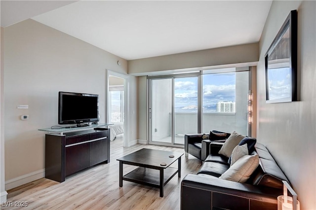 living area featuring light wood finished floors and baseboards