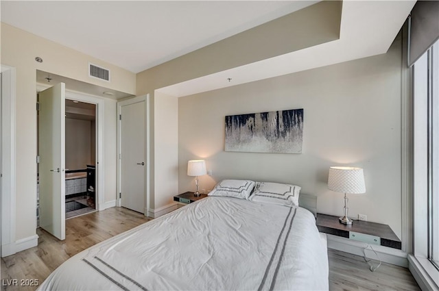 bedroom featuring visible vents, baseboards, and light wood-style flooring