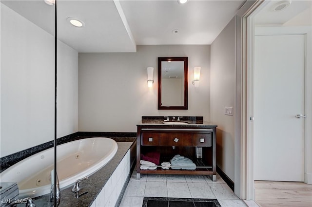 full bathroom with recessed lighting, vanity, a whirlpool tub, and tile patterned floors