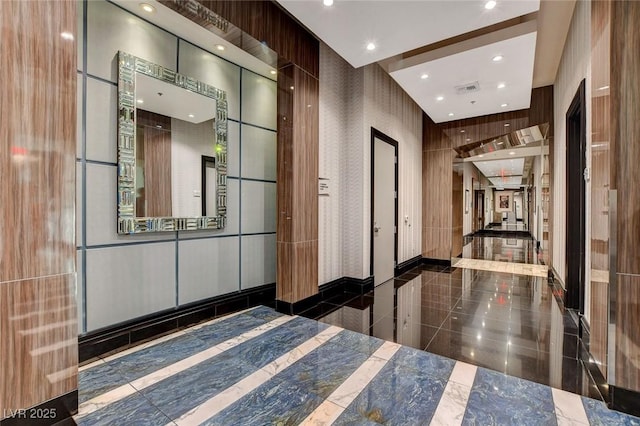 hallway featuring recessed lighting, visible vents, and granite finish floor