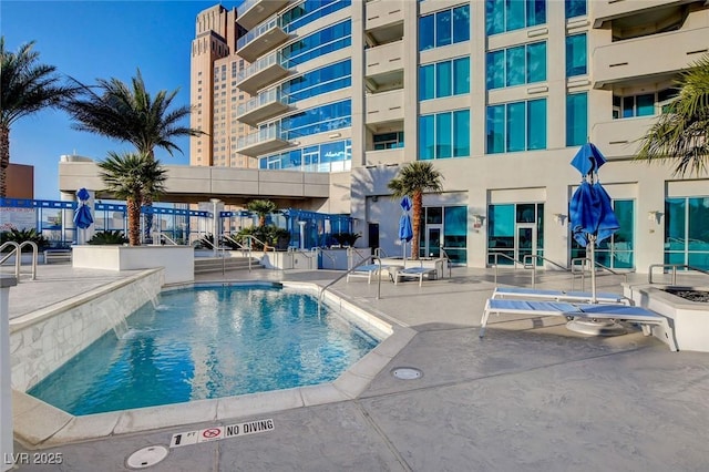 pool with fence and a patio area