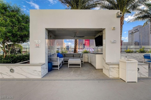 view of patio with an outdoor living space and a ceiling fan