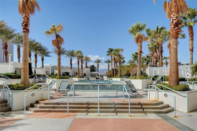 pool featuring fence and a patio area