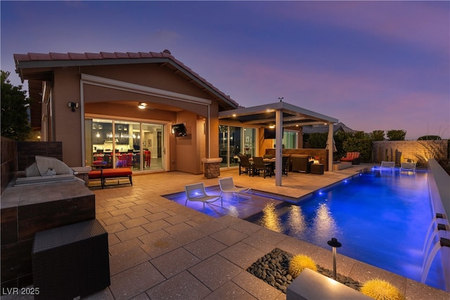 view of pool with a fenced backyard, a patio, a fenced in pool, and exterior kitchen