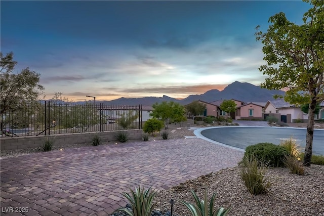 view of pool with a mountain view and fence