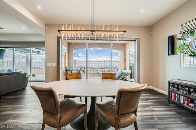 dining area with recessed lighting, a healthy amount of sunlight, and baseboards