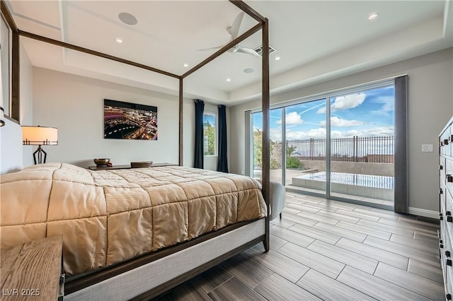 bedroom featuring visible vents, baseboards, a tray ceiling, recessed lighting, and access to outside