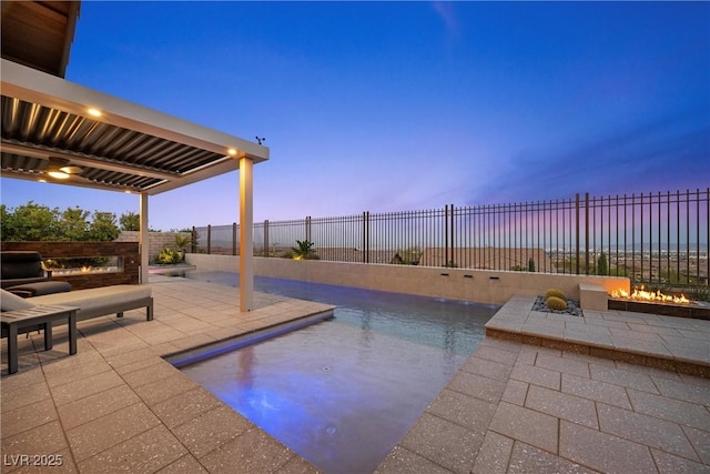 294 Besame Ct, Las Vegas, NV 89138 - pool at dusk featuring a patio, a fenced in pool, a fenced backyard, and an outdoor fire pit