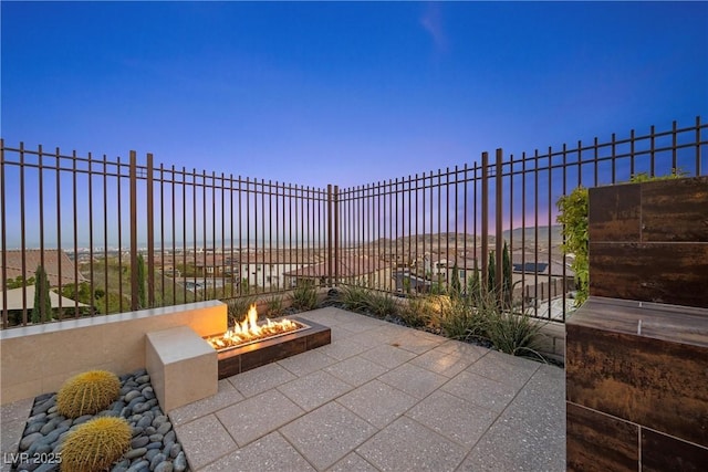 294 Besame Ct, Las Vegas, NV 89138 - patio terrace at dusk featuring fence and a fire pit