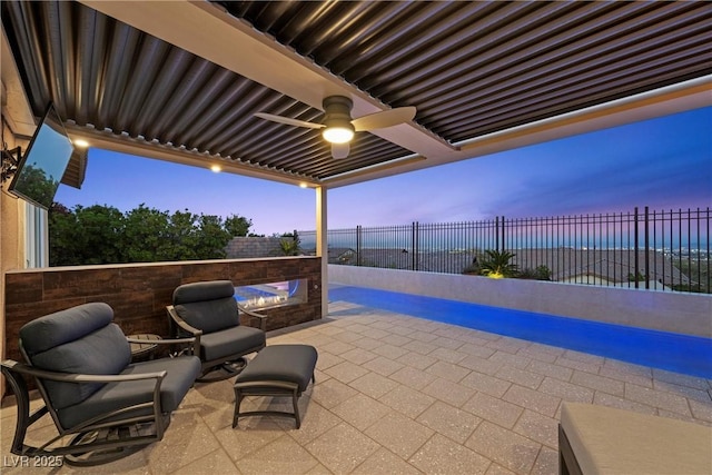 294 Besame Ct, Las Vegas, NV 89138 - view of patio with an outdoor fire pit, ceiling fan, a fenced backyard, a fenced in pool, and a water view