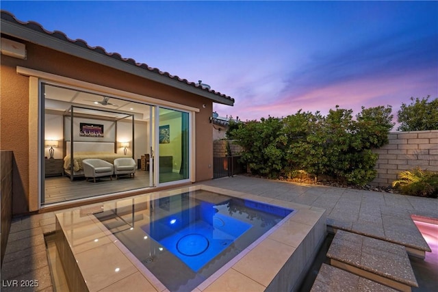 294 Besame Ct, Las Vegas, NV 89138 - pool at dusk featuring an in ground hot tub and fence