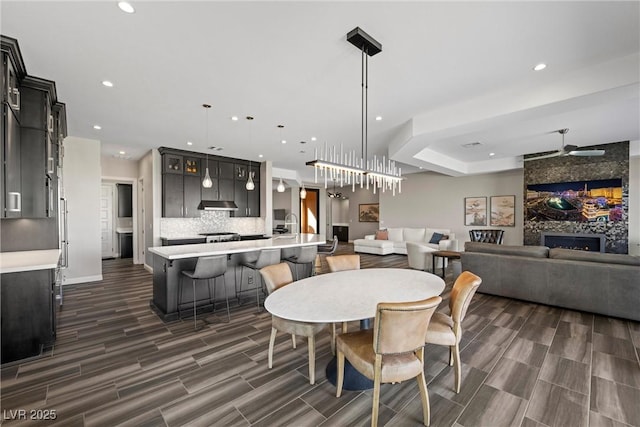 294 Besame Ct, Las Vegas, NV 89138 - dining space featuring recessed lighting, wood tiled floor, baseboards, and a large fireplace