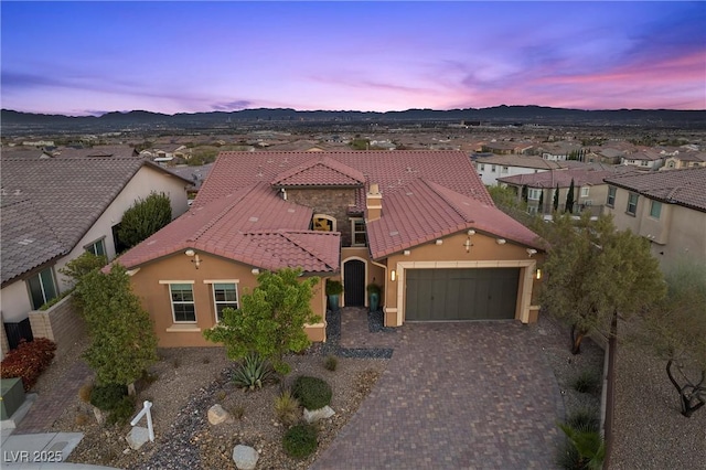 294 Besame Ct, Las Vegas, NV 89138 - mediterranean / spanish home with a tiled roof, driveway, a mountain view, an attached garage, and stucco siding