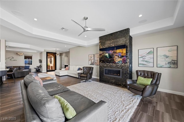 294 Besame Ct, Las Vegas, NV 89138 - living area featuring a raised ceiling, a ceiling fan, baseboards, wood finished floors, and visible vents