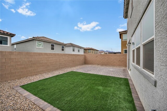 view of yard featuring a patio and a fenced backyard