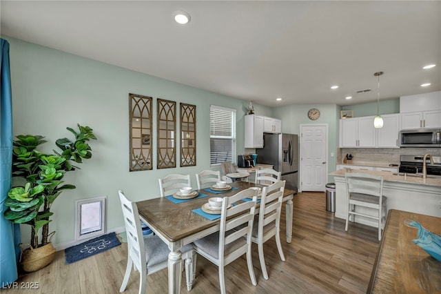 dining area with recessed lighting, visible vents, and light wood-style flooring