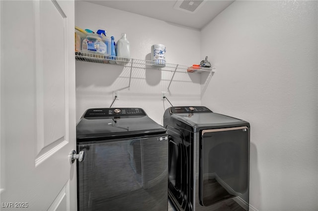 laundry room featuring laundry area, visible vents, and washing machine and clothes dryer
