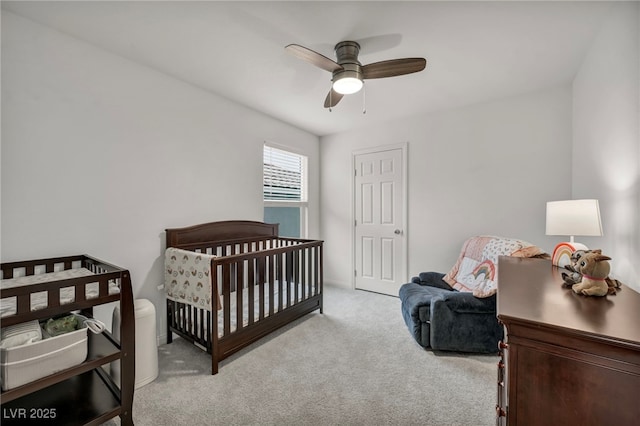 bedroom with a ceiling fan and light carpet