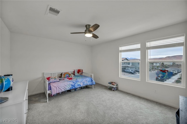 bedroom featuring visible vents, a ceiling fan, baseboards, and carpet floors