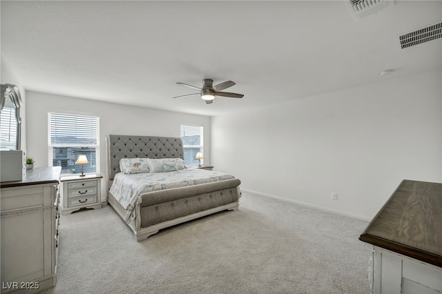 bedroom featuring visible vents, baseboards, light colored carpet, and ceiling fan