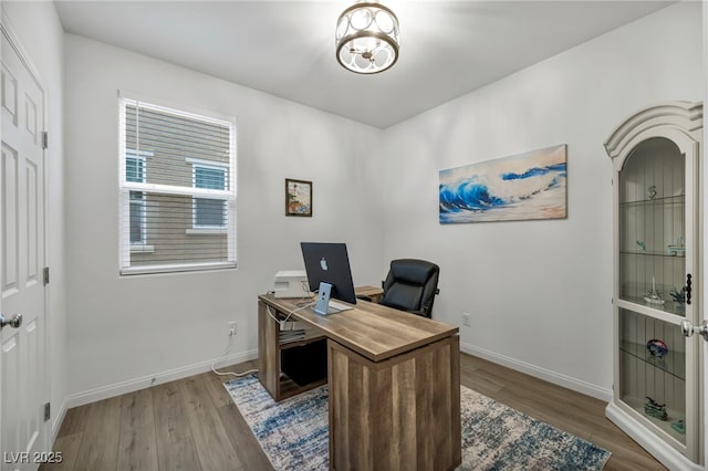 home office with wood finished floors and baseboards