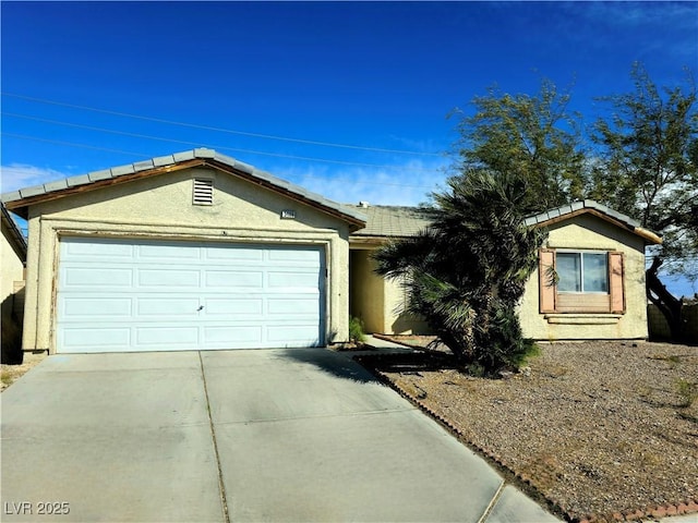 single story home featuring stucco siding, driveway, and an attached garage