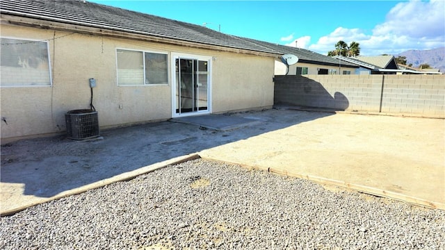 back of house with a patio area, fence, and stucco siding