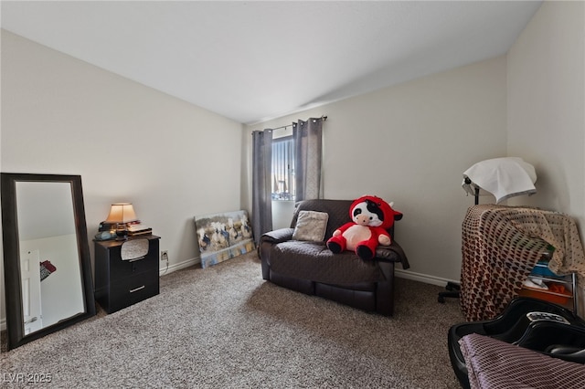 sitting room featuring carpet flooring, baseboards, and vaulted ceiling