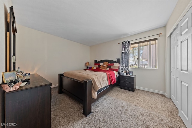 carpeted bedroom with baseboards and a closet