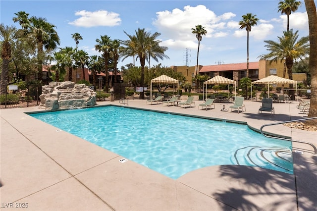 pool with a gazebo, fence, and a patio area